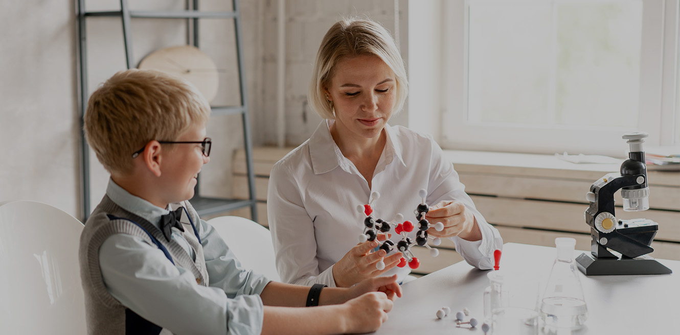 Female science tutor in Centennial studying chemistry with student