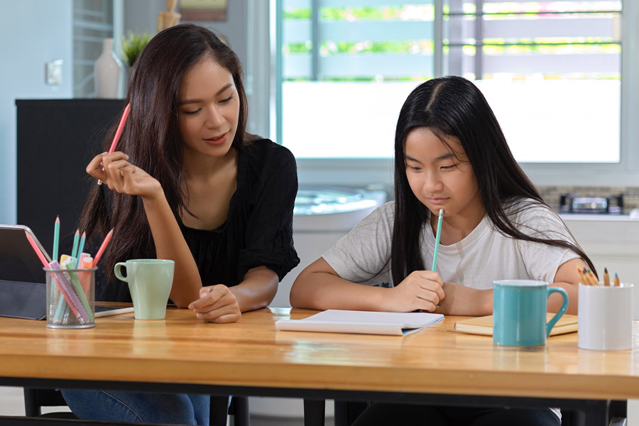 student and tutor together at a desk in Centennial